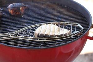 swordfish grilling on barbecue in fish accessory photo