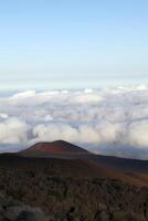 Lava and cinder cone with clouds blue sky photo