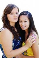 Two Women In Dresses Outdoors Asian American And Caucasian photo