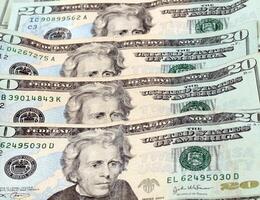 Overlapping US twenty dollar bills arranged vertically photo