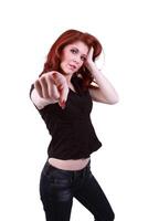 Young redhead woman pointing finger jeans and shirt photo