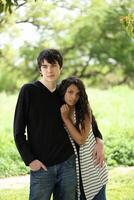 Young teen couple holding each other outdoors portrait photo