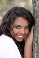 Young mixed teen girl outdoor portrait tree photo