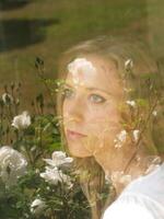 Young blond woman portait with flower reflections photo