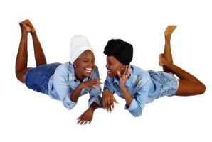Two Black Sisters Reclining Open Mouth Laugh photo