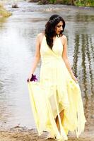 Young East Indian Woman In Yellow Dress At River photo