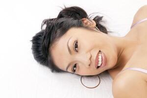 Portrait smiling Pacific Islander Woman reclining photo