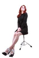 Young red headed woman on stool business dress photo