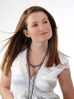 Young caucasian woman in white blouse and necklace photo