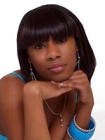 Portrait young black woman with chin on hands photo