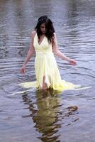 Young East Indian Woman Standing In River photo