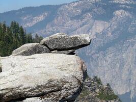 Granite rock formation with rugged background photo