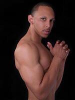 Fit African American Man Topless On Dark Background photo