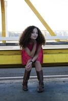 Young Mixed Black Woman Red Dress Sitting photo