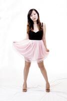 Chinese American Woman Standing In Black And Pink Dress photo