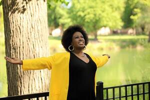 Middle Aged Black woman with arms outstretched photo