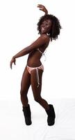 Young black woman in bikini and boots photo