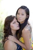 Portrait of Two Woman Outdoors Close Together photo