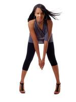 Skinny young black woman in pants and grey top photo