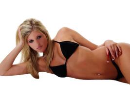 Reclining Caucasian Blond Woman In Black Bikini photo