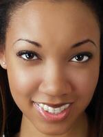 Tight closeup portrait of young black woman photo