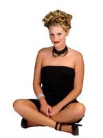 Caucasian Blond Woman Sitting In Black Dress photo