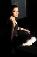 Attractive Young African American Woman Sitting In Dance Outfit photo