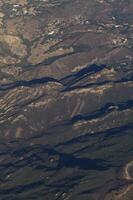 Aerial Image Of Hills With Some Dwellings Mostly Green Trees photo