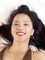 Young hispanic woman with big smile reclining photo