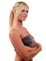 Young blond woman with arms crossed looking skeptical photo