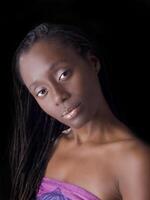 Young black woman portrait against dark background photo