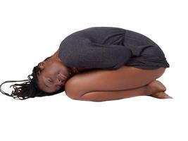 Young black woman in gray knit dress on knees photo