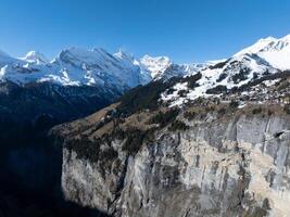 Aerial View of Murren, Switzerland  Alpine Town Amid Snow Capped Peaks photo