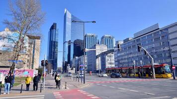 Warsaw, Poland. 7 March 2024. Public transportation tram in the city center in the morning against a background of modern buildings. photo