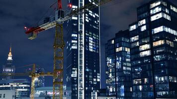 Warsaw, Poland. 6 March 2024. Night view of the apartment building construction site and Varso Place, modern business center. photo