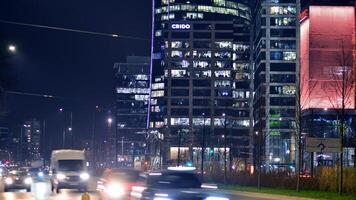 Warsaw, Poland. 6 March 2024. Night in Warsaw city center. Motion blurred car traffic. Lights and illumination Towarowa street. photo