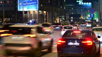 Warsaw, Poland. 6 March 2024. Night in Warsaw city center. Motion blurred car traffic. Lights and illumination Towarowa street. photo