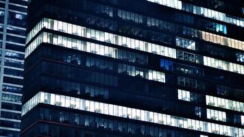 Office buildings by night. Night architectural, buildings with glass facade. Modern buildings in business district. Concept of economics, financial. photo