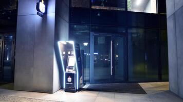 Warsaw, Poland. 6 March 2024. Night view of the entrance to the headquarters of Pko Bank Polski. View of atm Pko Bank Polski. photo