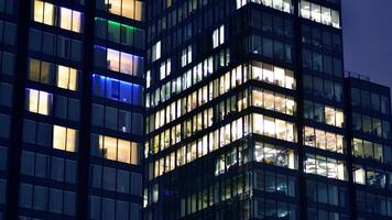 Office buildings by night. Night architectural, buildings with glass facade. Modern buildings in business district. Concept of economics, financial. photo