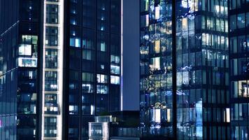 Office buildings by night. Night architectural, buildings with glass facade. Modern buildings in business district. Concept of economics, financial. photo