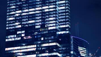 Office buildings by night. Night architectural, buildings with glass facade. Modern buildings in business district. Concept of economics, financial. photo