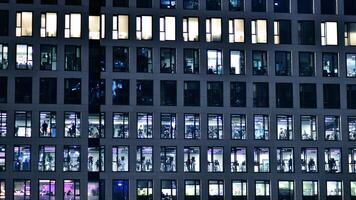 Office buildings by night. Night architectural, buildings with glass facade. Modern buildings in business district. Concept of economics, financial. photo