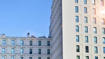 View of a white modern apartment building. Perfect symmetry with blue sky. Geometric architecture detail modern concrete structure building. Abstract concrete architecture. photo