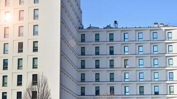 View of a white modern apartment building. Perfect symmetry with blue sky. Geometric architecture detail modern concrete structure building. Abstract concrete architecture. photo