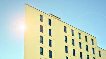 View of a white modern apartment building. Perfect symmetry with blue sky. Geometric architecture detail modern concrete structure building. Abstract concrete architecture. photo