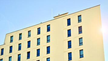 View of a white modern apartment building. Perfect symmetry with blue sky. Geometric architecture detail modern concrete structure building. Abstract concrete architecture. photo