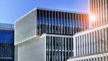 Modern office building in the city with windows and steel and aluminum panels wall. Contemporary commercial architecture, vertical converging geometric lines. photo