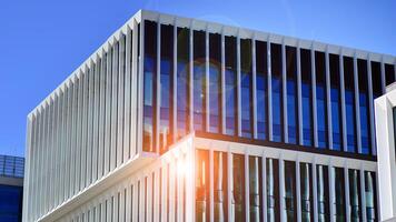 Modern office building in the city with windows and steel and aluminum panels wall. Contemporary commercial architecture, vertical converging geometric lines. photo