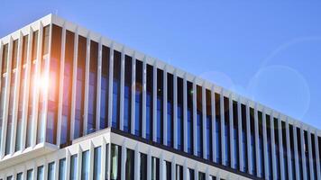 Modern office building in the city with windows and steel and aluminum panels wall. Contemporary commercial architecture, vertical converging geometric lines. photo